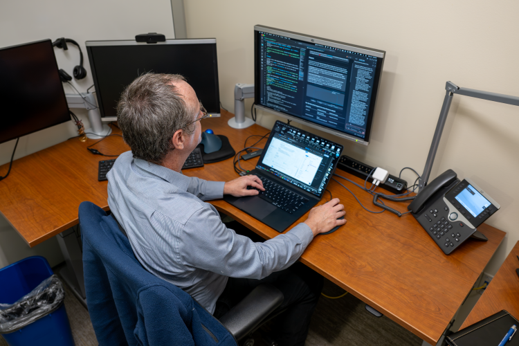 Dr. Jamie Estill programming in his office.